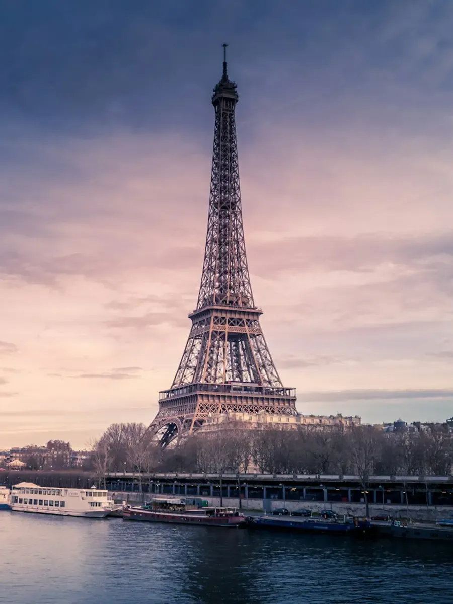 The Eiffel Tower over the Seine at twilight
