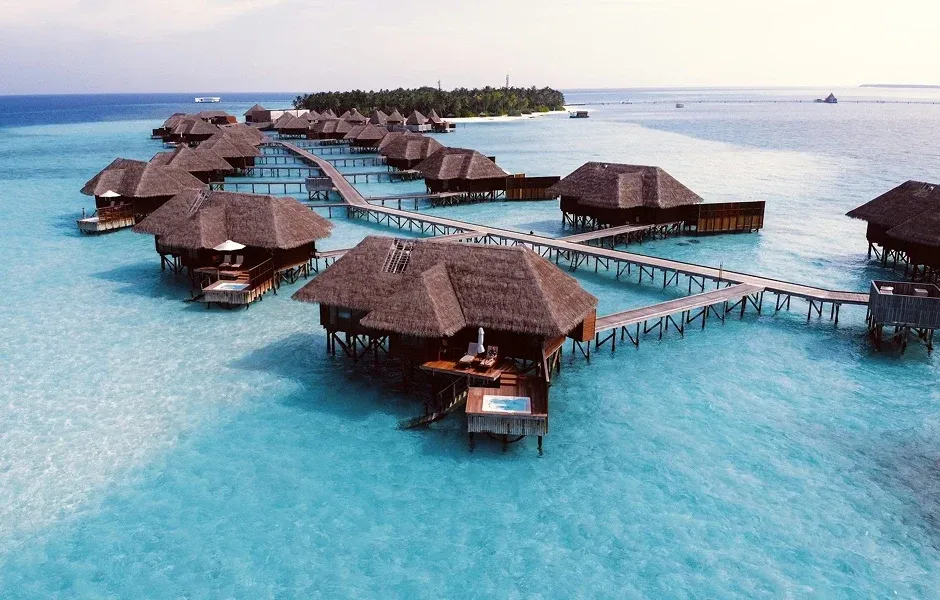Overwater bungalow at sunset in the Maldives